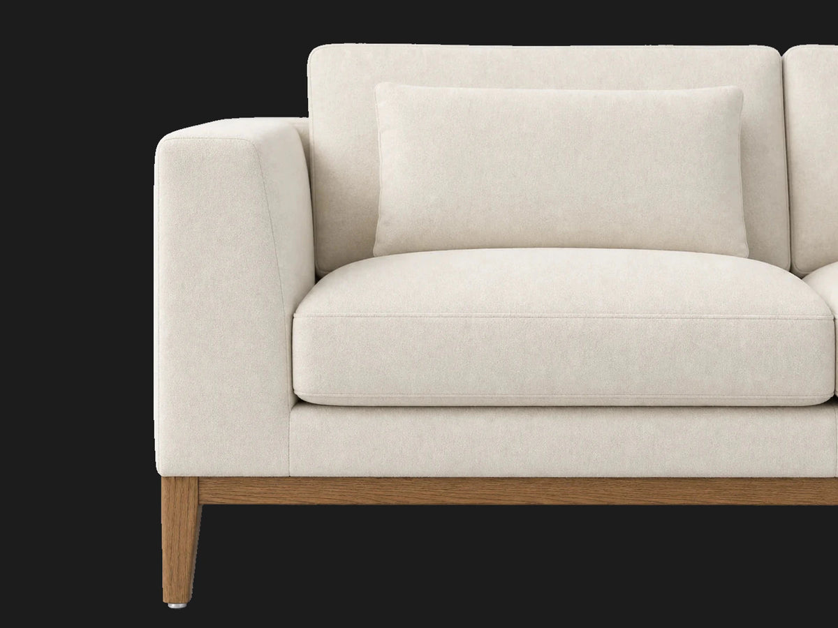 E310952588 sofa detail arm cushion view in Italian Brushed Wool Vanilla with oak base