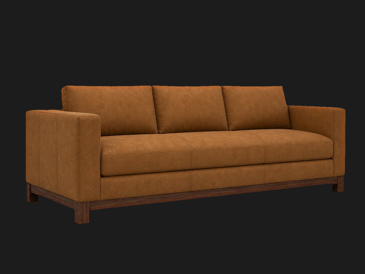 Jake sofa 45 degree left view in Nubuck Leather Saddle with walnut finish