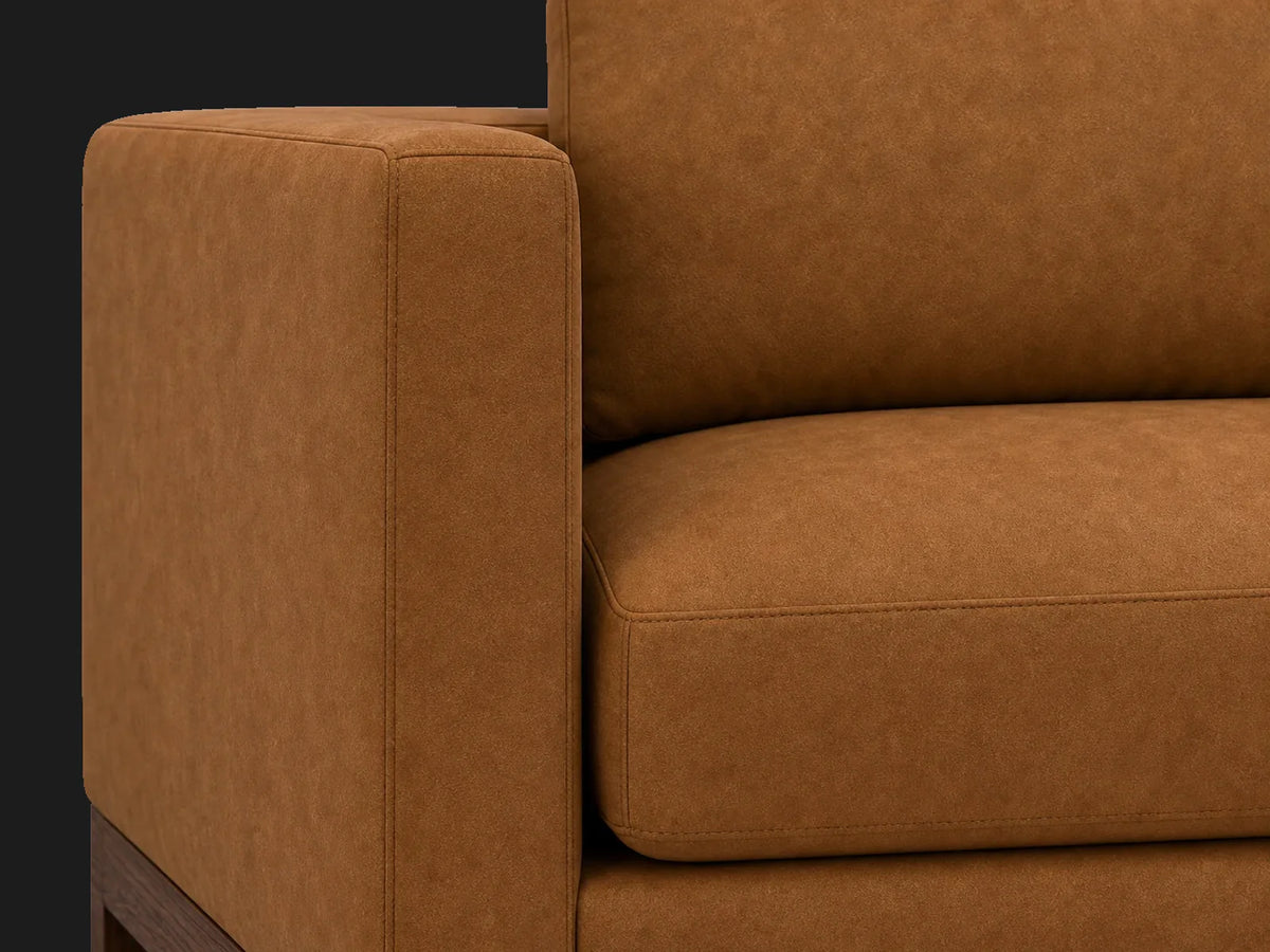 Jake sofa cushion detail in Nubuck Leather Saddle with walnut finish