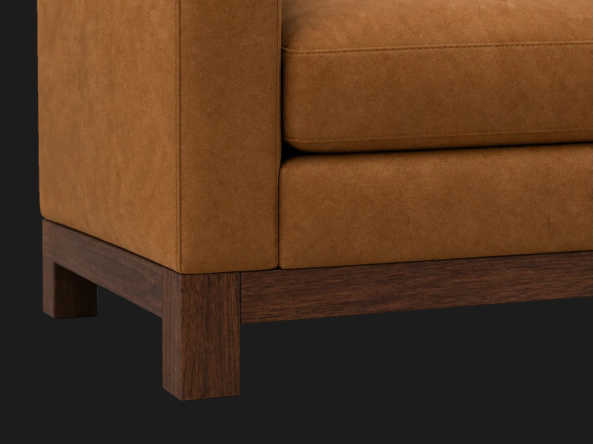 Jake sofa leg detail in Nubuck Leather Saddle with walnut finish