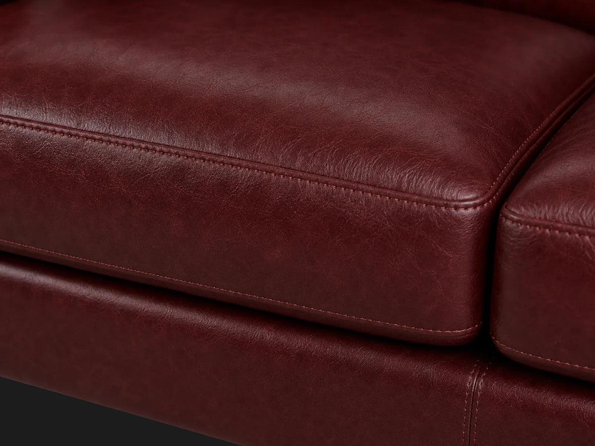 Turner sofa cushion stitching detail in Oxblood aniline leather