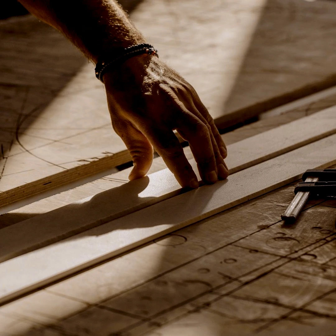 Hand checking a wood template and drawing before production