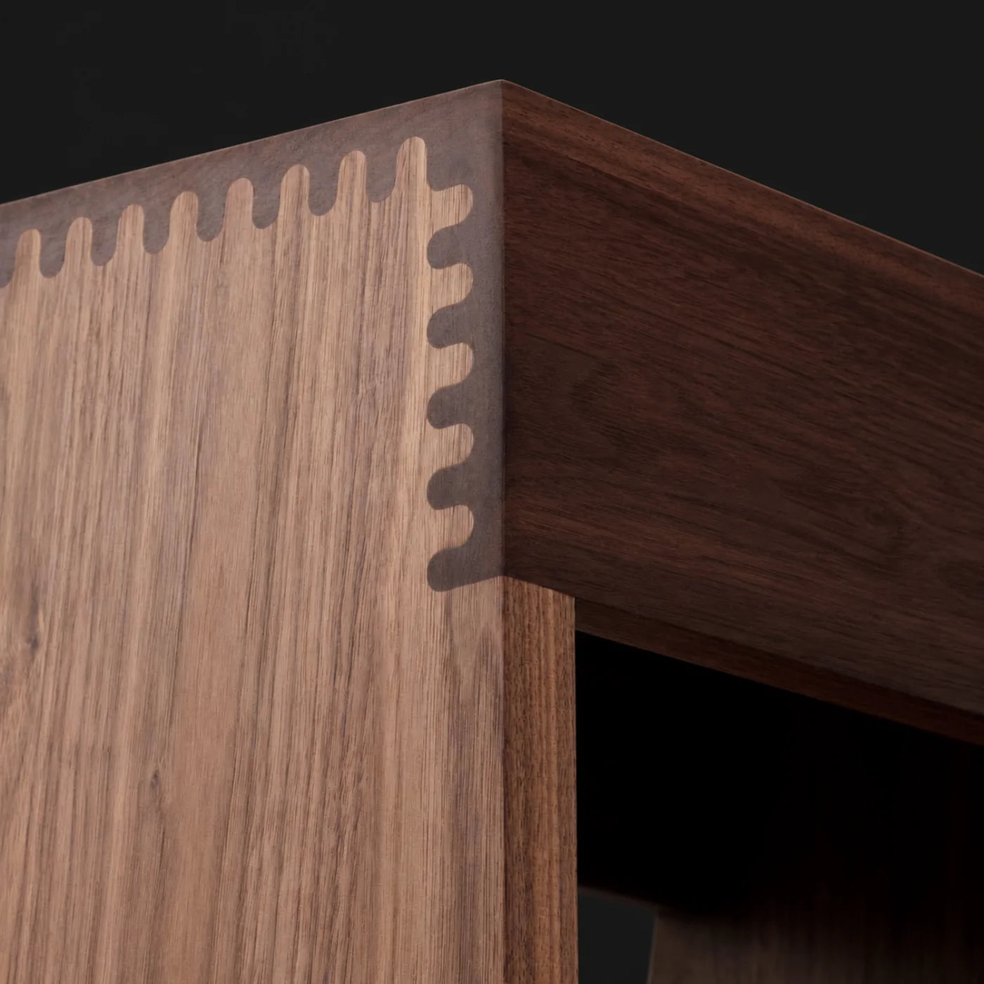 Interlocking load-bearing wood joinery at a furniture corner